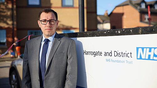 Tom Gordon by an NHS sign at Harrogate District Hospital