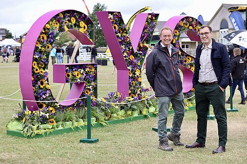 Tom Gordon and Tim Farron at Great Yorkshire Show, in front of a large 3D sign reading 'GYS'