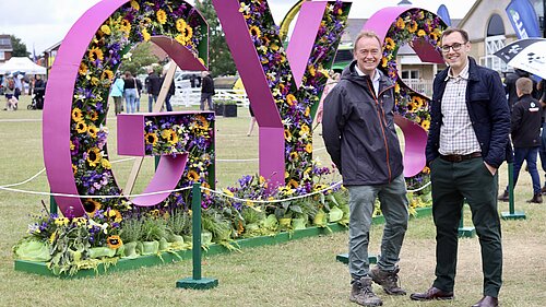 Tom Gordon and Tim Farron at Great Yorkshire Show, in front of a large 3D sign reading 'GYS'