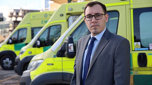 Tom stood in front of ambulances at Harrogate District Hospital