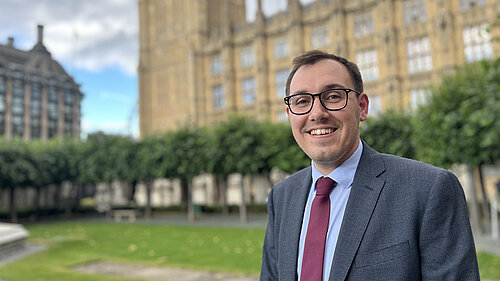 Tom Gordon stood in front of the Houses of Parliament