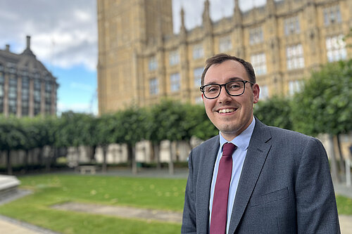 Tom Gordon stood in front of the Houses of Parliament