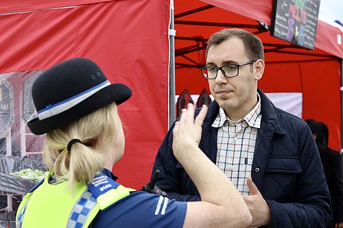 Tom Gordon stood talking to a policewoman in uniform