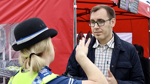 Tom Gordon stood talking to a policewoman in uniform