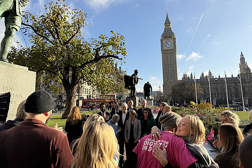 Tom Gordon with Kim Leadbeater and other MPs with Dignity in Dying activists on Parliament Green by the Houses of Parliament