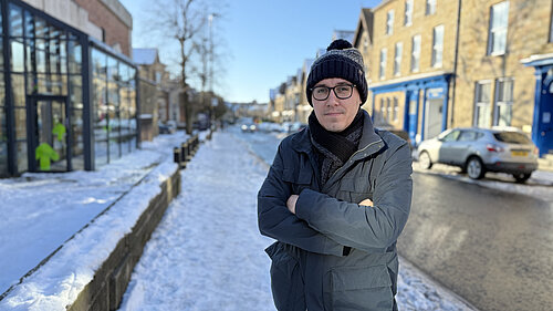 Tom Gordon stood in a hat scarf and coat on Westmorland Street in the snow