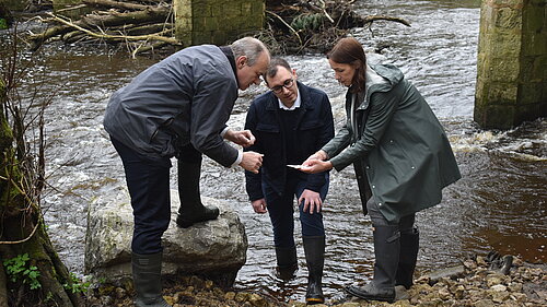 Tom Gordon with Ed Davey MP and Cllr Hannah Gostlow taking samples from the River Nidd to check for E Coli bacteria and sewage